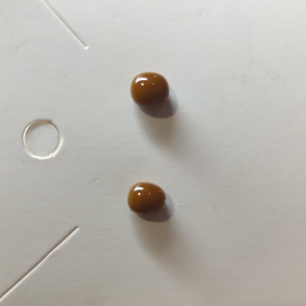 Artisan Handmade small brown opaque glass studs. .25m in size.